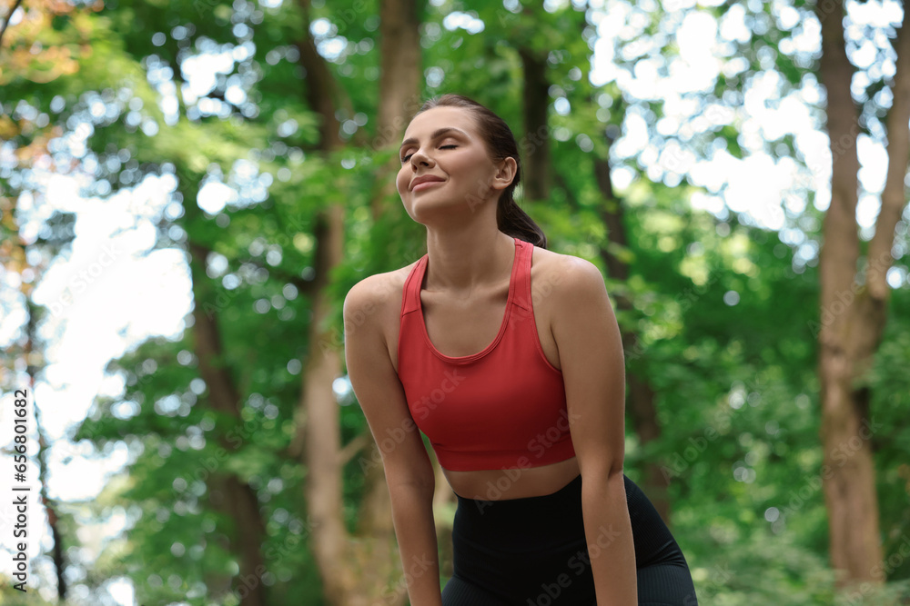 Beautiful woman in sportswear resting in park Beautiful woman in sportswear resting in park