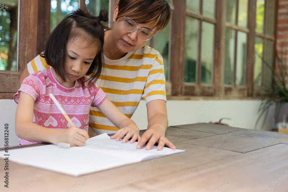A beautiful moment of family connection and learning. A mother and her adorable daughter are engrossed in an educational activity. Seated together at an outdoor table under the gentle sunlight. A beautiful moment of family connection and learning. A mother and her adorable daughter are engrossed in an educational activity. Seated together at an outdoor table under the gentle sunlight.