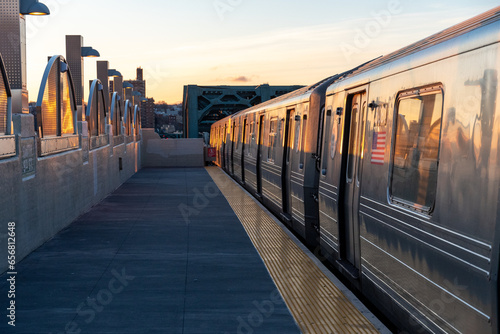 Sunrise on the train platform as the G Train arrives at the Smith Street station over the Gowanus Canal in Brooklyn, New York. 