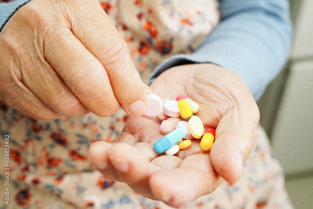 Asian elderly woman holding pill drug in hand, strong healthy medical concept. Asian elderly woman holding pill drug in hand, strong healthy medical concept.