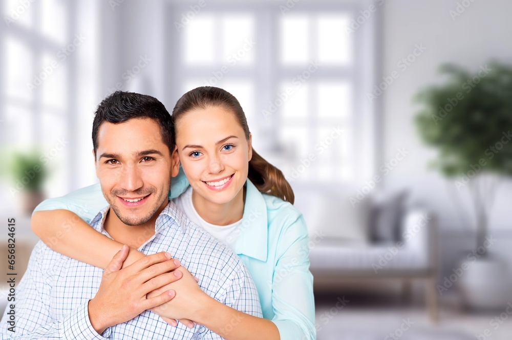 Happy young couple having fun at home in room Happy young couple having fun at home in room