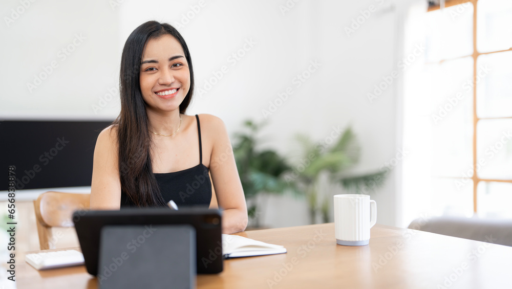 Portrait of smiling happy beautiful asian woman using laptop computer while sitting at home. Portrait of smiling happy beautiful asian woman using laptop computer while sitting at home.