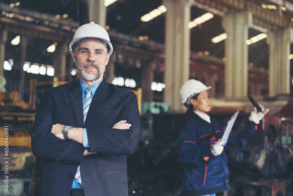 Senior male business manager working and inspecting of project in the industry factory Senior male business manager working and inspecting of project in the industry factory