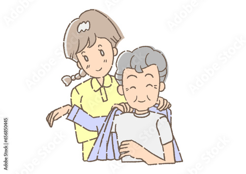 介護士に、着替えを手伝ってもらっている、おじいさん。