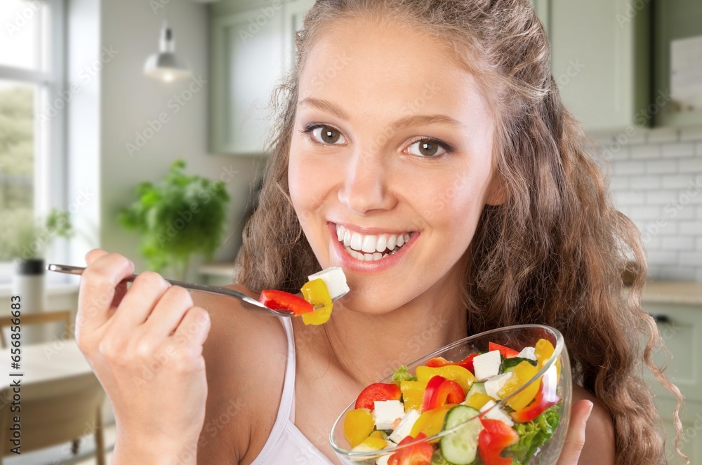 Happy young woman eats fresh fruits Happy young woman eats fresh fruits