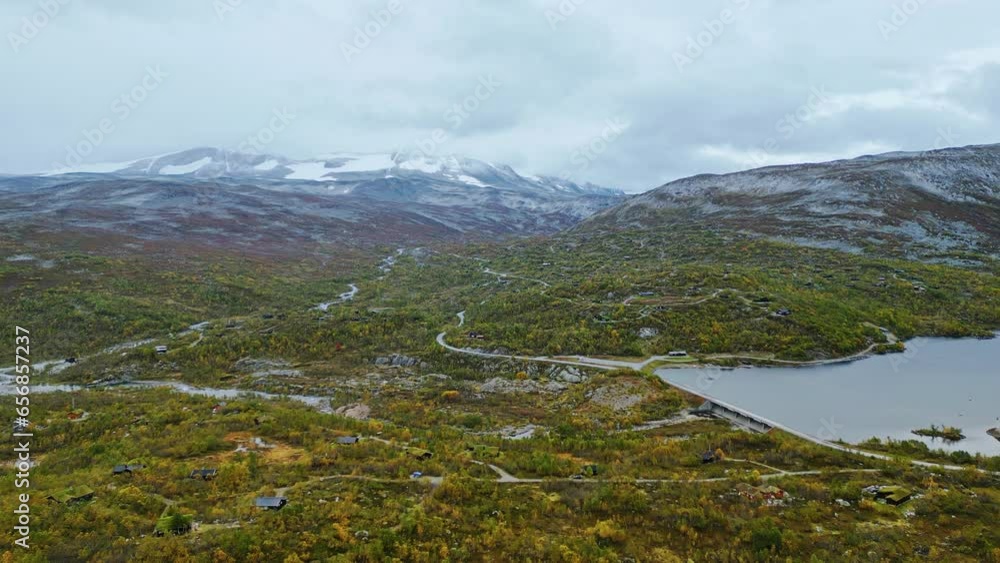 Aerial over the forested hills near Breheimen, Norway. Drone crane down dolly back shot Aerial over the forested hills near Breheimen, Norway. Drone crane down dolly back shot