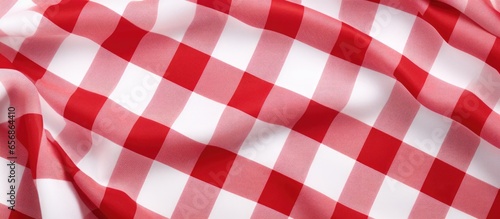 Red and white textured fabric with a scotch pattern viewed from the top on a white background with space for text