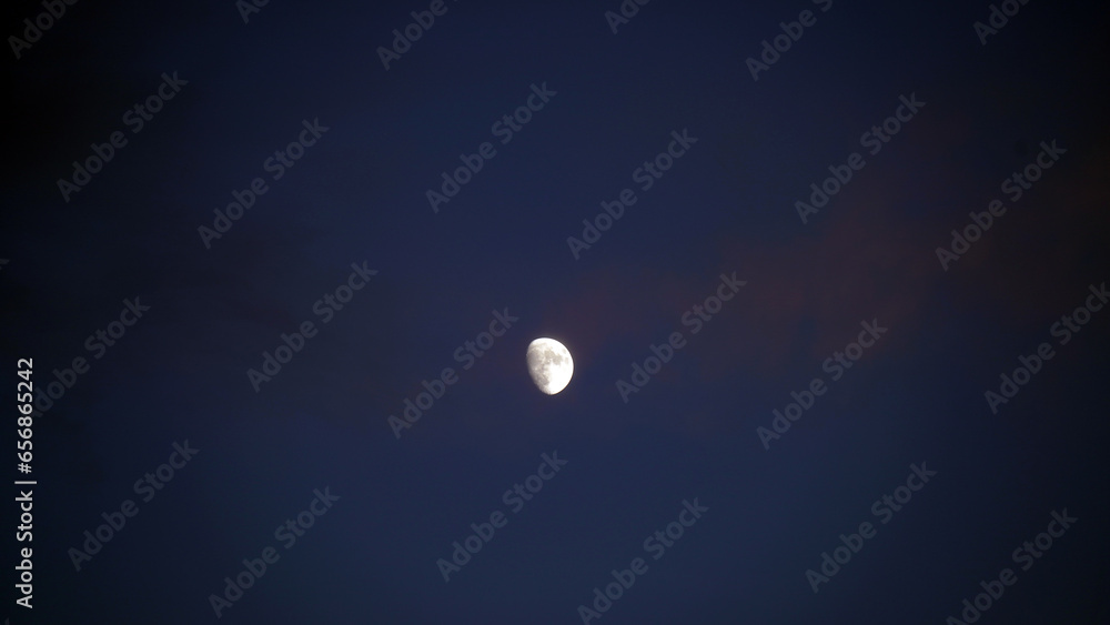 Full moon over clouds. Shone circle of the moon in darkness on a background of the star sky and clouds Full moon over clouds. Shone circle of the moon in darkness on a background of the star sky and clouds