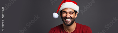 portrait of handsome smiling man in santa claus wearing photo