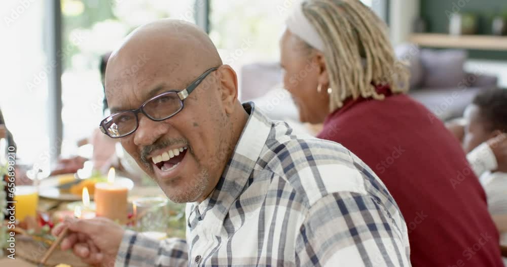 Portrait of african american grandfather with family at thanksgiving dinner table, slow motion Portrait of african american grandfather with family at thanksgiving dinner table, slow motion