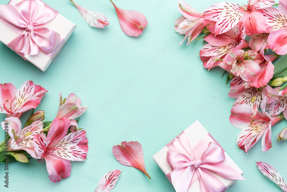 Beautiful Alstroemeria flowers and gift boxes on light green background