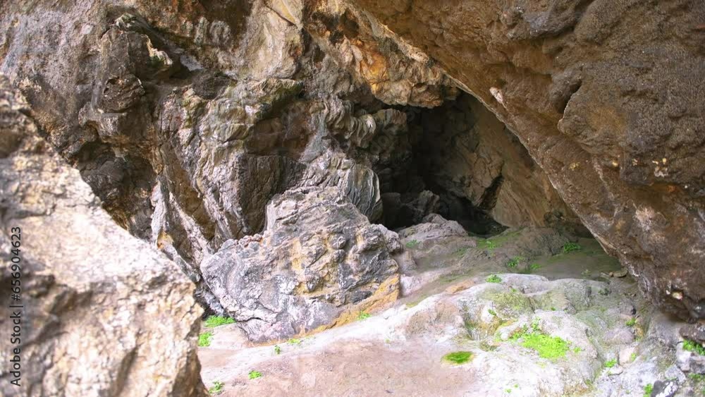 Iero beach cave birthplace of Greek god Dionysos or Dyonysus temple on Ikaria island Greece cove by Ikarian sea, cliff rocks Iero beach cave birthplace of Greek god Dionysos or Dyonysus temple on Ikaria island Greece cove by Ikarian sea, cliff rocks