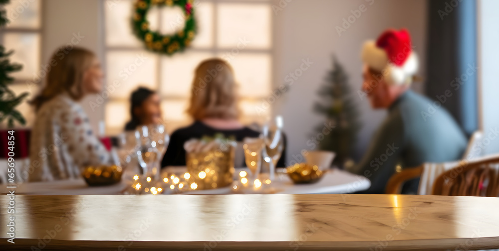 empty wooden table with beautiful out of focus family celebrating on christmas day