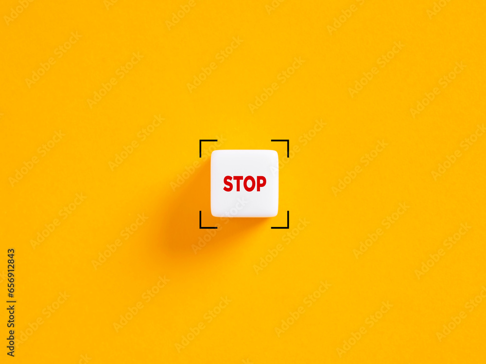 Stop push button. The word stop on white cube on yellow background. - obrazy, fototapety, plakaty 