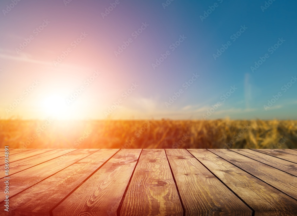 Wooden table on blur field background