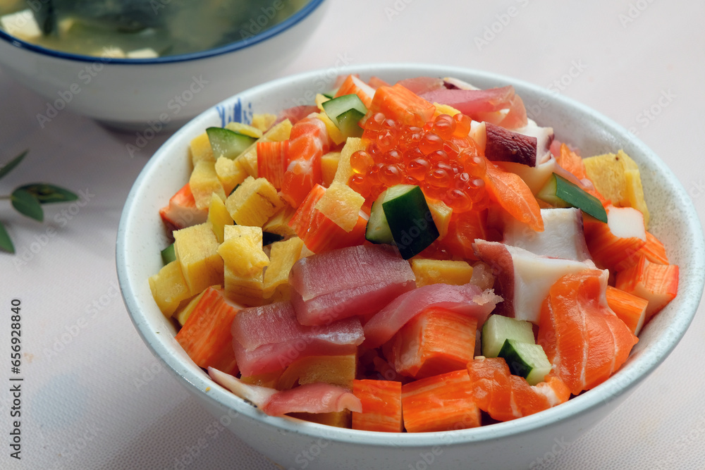 A bowl of cube cutting fresh fishes including tuna salmon fish’s eggs
