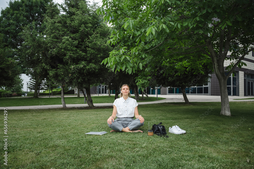 Businesswoman meditating in office park