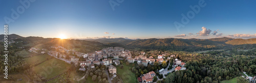 Italy, Tuscany, Torniella, Aerial panorama of mountain village at sunset