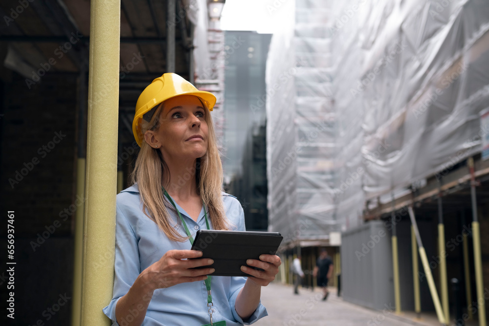 Contemplative engineer holding tablet PC Contemplative engineer holding tablet PC