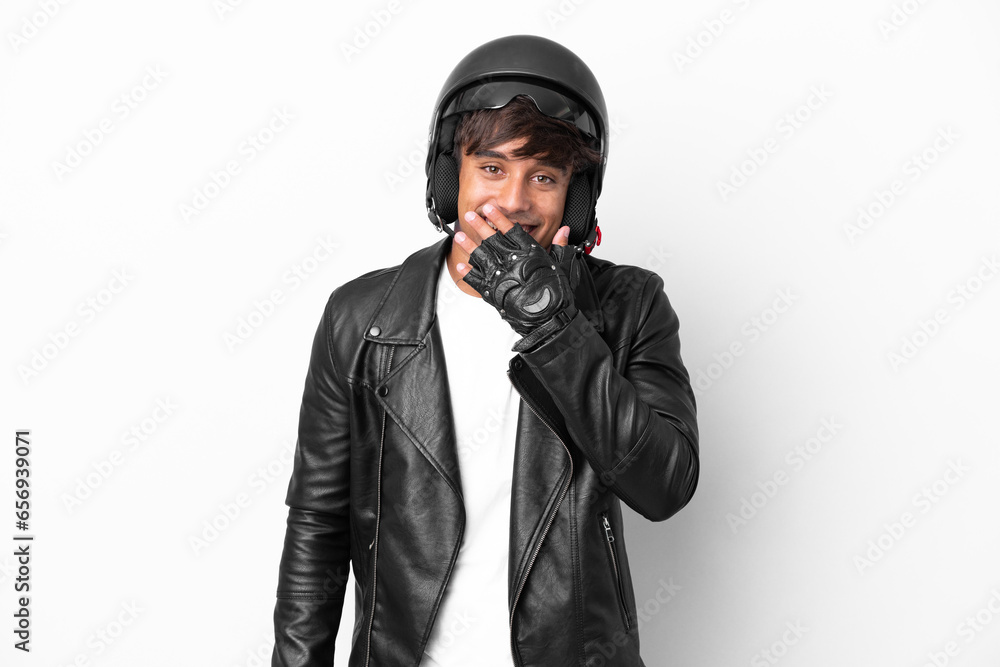 Young man with a motorcycle helmet isolated on white background happy and smiling covering mouth with hand Young man with a motorcycle helmet isolated on white background happy and smiling covering mouth with hand