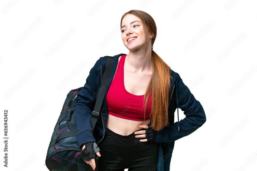 Young sport woman with sport bag over isolated chroma key background posing with arms at hip and smiling Young sport woman with sport bag over isolated chroma key background posing with arms at hip and smiling