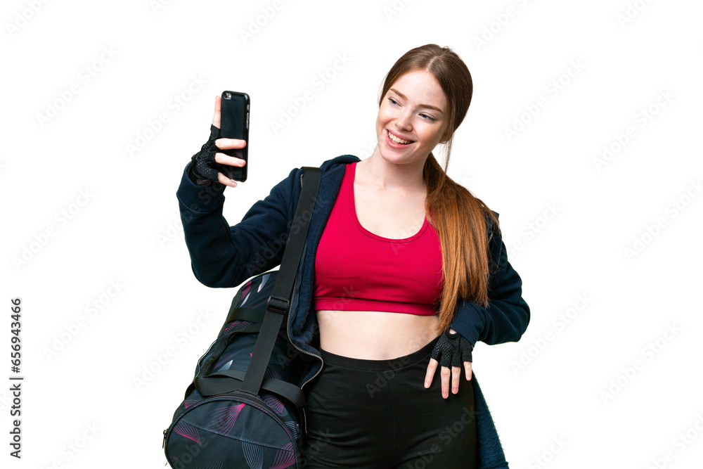 Young sport woman with sport bag over isolated chroma key background making a selfie Young sport woman with sport bag over isolated chroma key background making a selfie