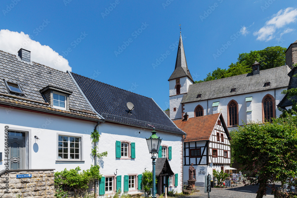 Germany, North Rhine Westphalia, Blankenheim,Historic houses in front of St. Maria Himmelfahrt church Germany, North Rhine Westphalia, Blankenheim,Historic houses in front of St. Maria Himmelfahrt church