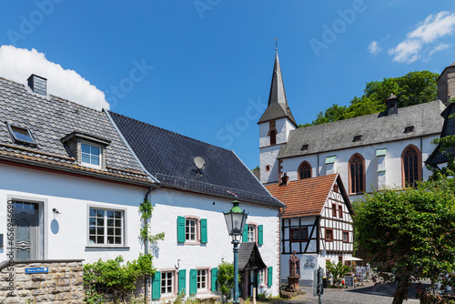 Germany, North Rhine Westphalia, Blankenheim,Historic houses in front of St. Maria Himmelfahrt church photo