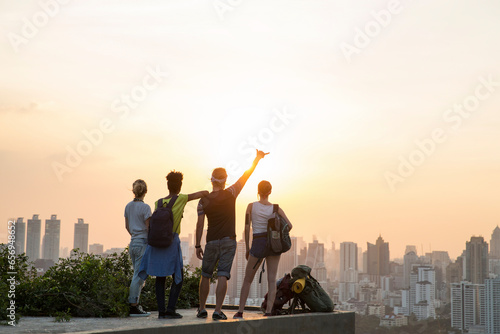 Friends enjoying sunset view from rooftop