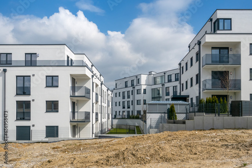 Germany, Bavaria, Odelzhausen, Modern suburban buildings with construction site in foreground photo
