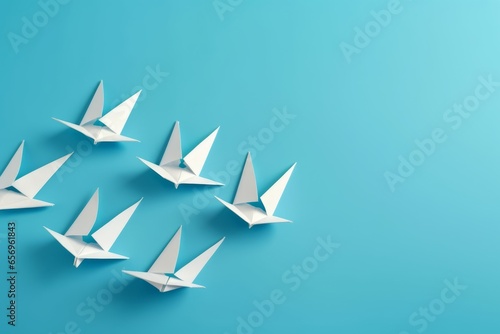 White origami birds on a vibrant blue background