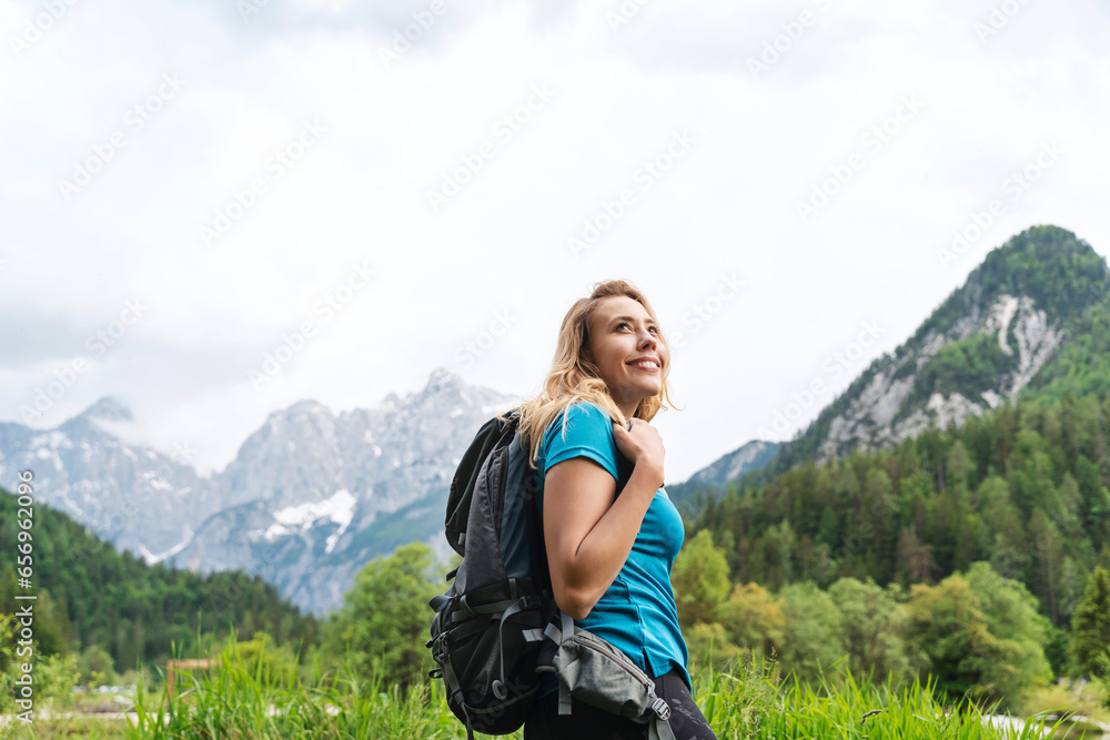 Smiling backpacker hiking by mountain Smiling backpacker hiking by mountain