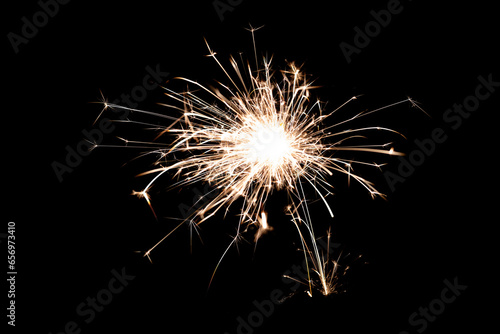 Sparkling burning sparkler on a black background.