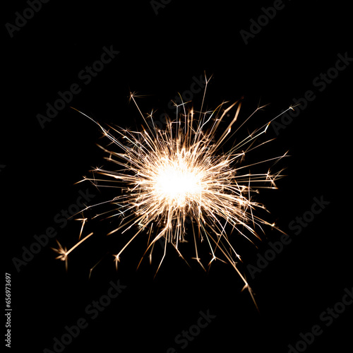 Sparkling burning sparkler on a black background.