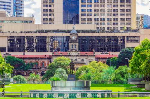 Australia, Queensland, Brisbane, Grand Central Hotel and Central Railway Station with statue in foreground photo