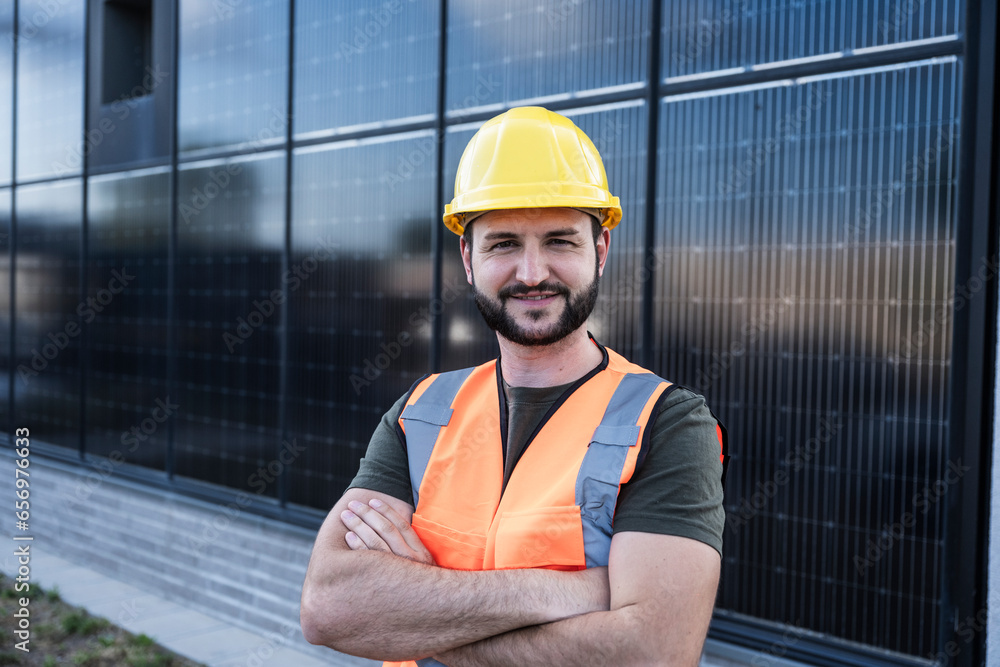 Confident engineer with arms crossed in front of solar panels Confident engineer with arms crossed in front of solar panels