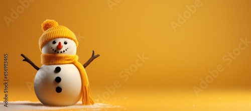 A holiday snowman in front of a cheerful yellow background. © Ivy