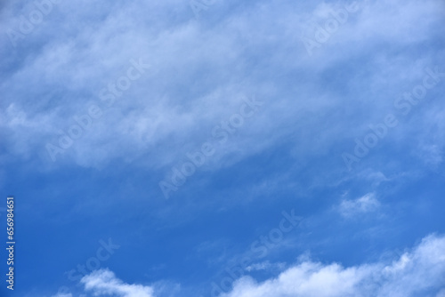 White clouds on a blue sky. Clusters of white clouds of various shapes. round and soft white clouds