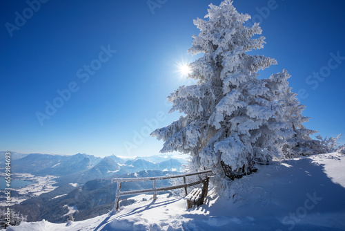 Austria, Salzburger Land, Saint Gilgen, Bench on snowcappedsummit ofZwolferhorn mountain