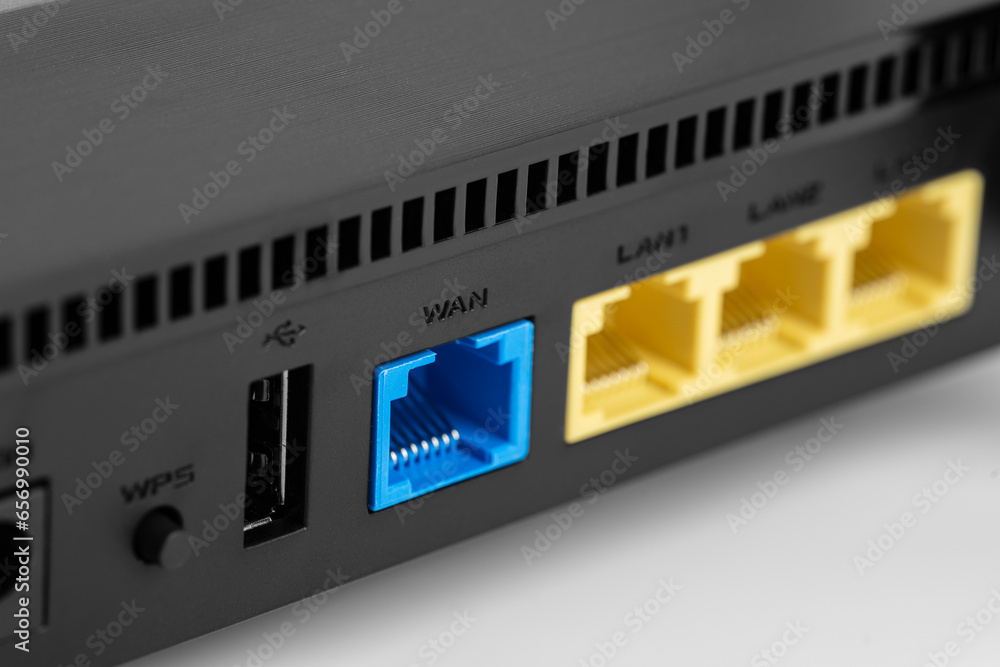 Black wireless internet router isolated on white background. 
Wireless Wi-Fi router isolated on white. Fiber Optic Internet. Network cables Connected to a router, speed test concept.