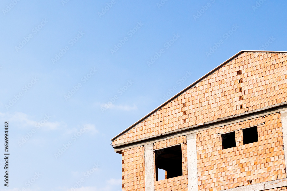 brick house with blue sky on the background