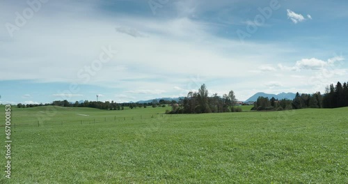 Near Sachsenkam south of Munich along the roads of Kirchsee and Stubenbach with view on green meadows and hills around  Reutberg monastery and brewery and Bavarian Alps on the horizon photo