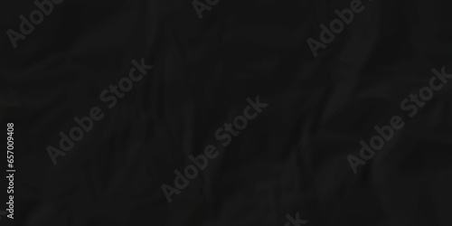 Crumpled paper texture. black crumpled paper texture. top view. crush paper so that it becomes creased and wrinkled. Old black crumpled paper sheet background texture. 