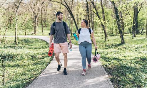 Valokuva A young couple, including a beautiful overweight woman, heads to the park with enthusiasm, ready for an invigorating outdoor workout that promotes health and togetherness