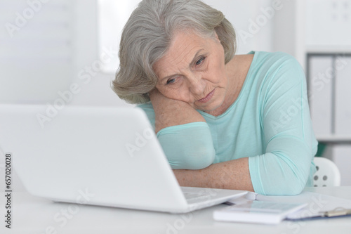 old woman with a laptop on a white background