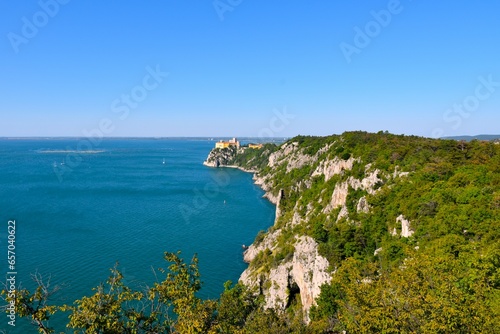 View of the cliffs of Duino at the coast of the Adriatic sea and Duino castle at Duino-Aurisina, Italy