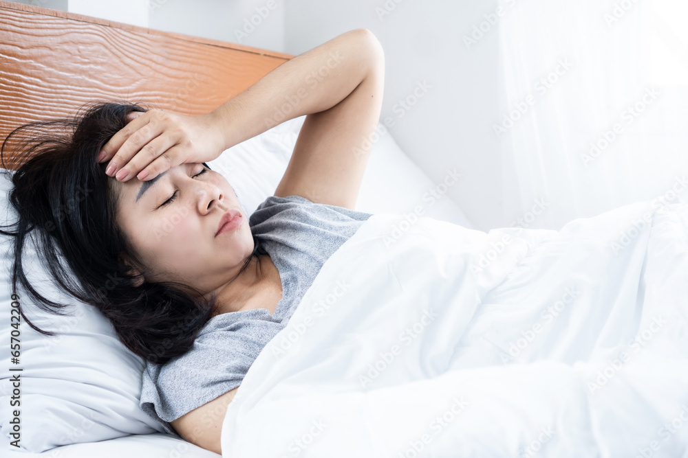 morning headache, dizziness with unwell Asian woman wake up in bed morning headache, dizziness with unwell Asian woman wake up in bed