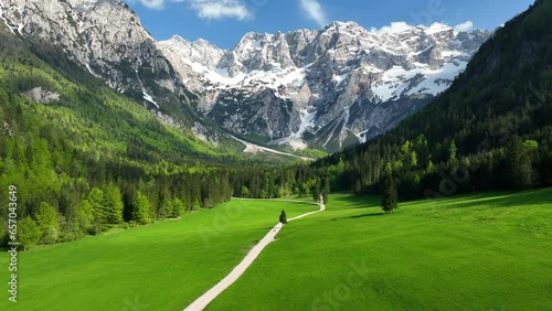 Zgornje Jezersko valley in Slovenia aerial view during a springtime sunset with the mountain range around the Grintovec mountain peak in the Kamnik Savinja Alps.