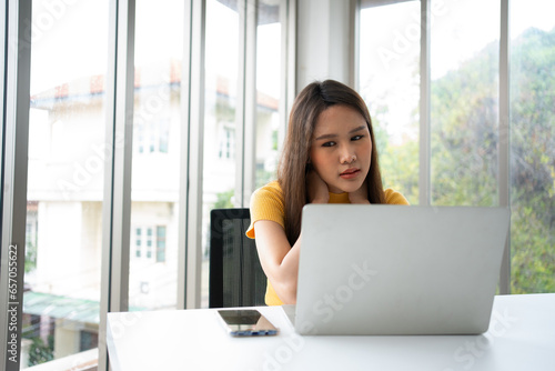 Beautiful young Asian businesswoman, shoulders and back pain during work long time on workplace. Body muscles stiff problem after long day work and overworked. Office syndrome and Healthcare concept.