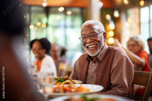Portrait of a happy senior African American man chatting while eating